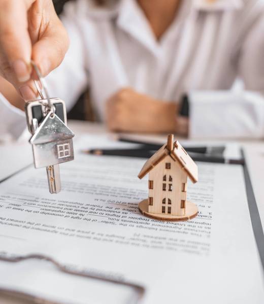 Woman real estate agent gives keys paperwork and miniature house model. Concept of buying apartment, rental contract signing, trusted agency service and modern housing ownership